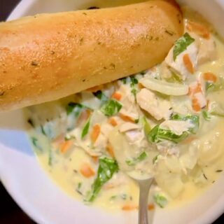 bowl of chicken gnocchi soup with breadstick